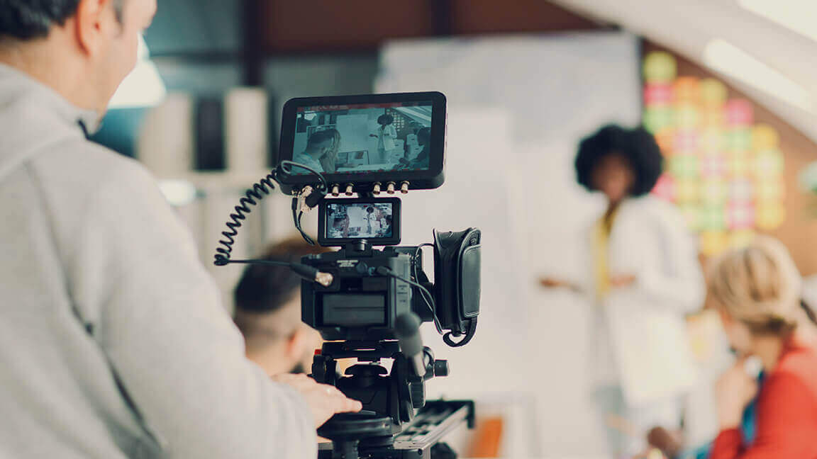 A camera man filming a presentation