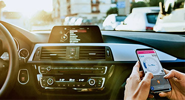 A person using a phone app on a car passenger seat