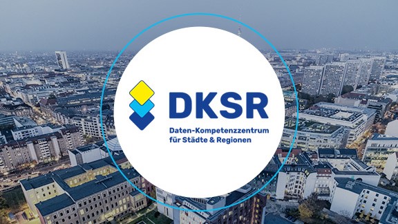 Logo DKSR, in the background a city