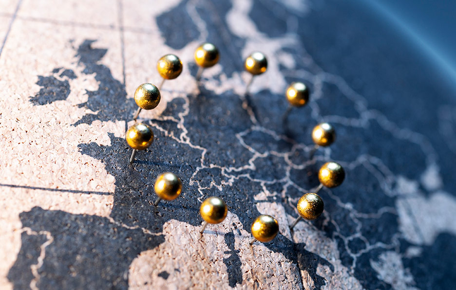 Map of Europe with gold pins.