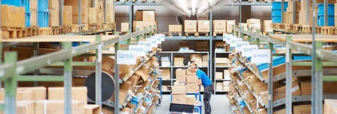 Photo of a warehouse with an employee.