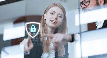 A woman and a man point their fingers at a digital lock on a glass wall 