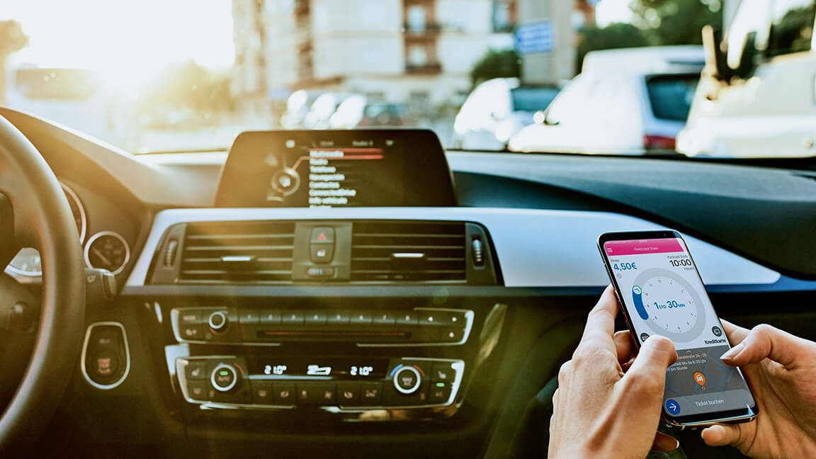 A person using a phone app on a car passenger seat