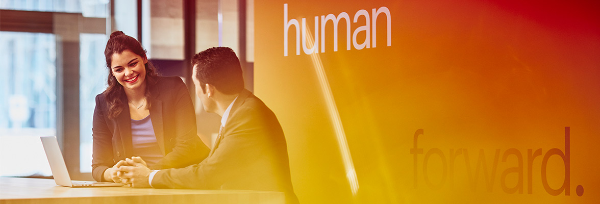 Two people using a laptop in Randstad office