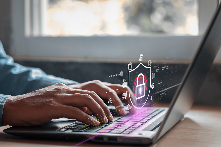 Hands of a man on a laptop keyboard, in the foreground a digital icon with a padlock