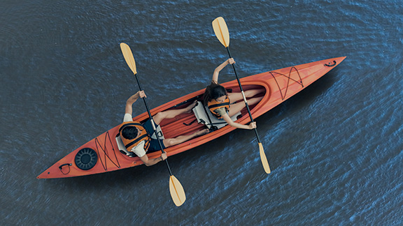 Two people in a canoe viewed from above.