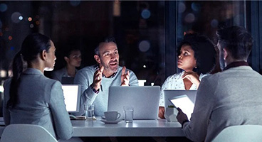 People in a meeting room working together on a project.