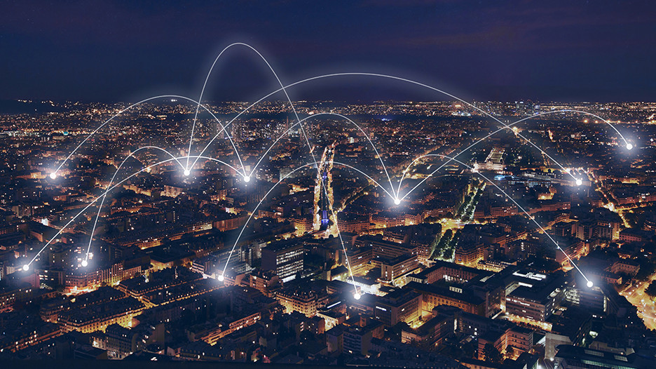 White connecting lines between houses in a city at night