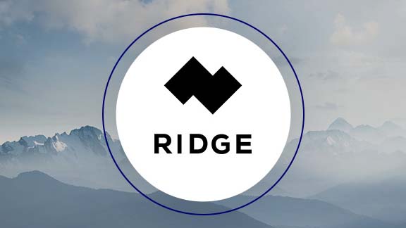 Ridge Logo vor einem Foto von wolkenverhangenen Bergen mit Schnee.