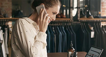 Woman pays with smartphone at card reader