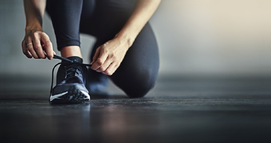 Runner lacing up her shoes.