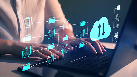 Hands on a keyboard symbolizing the data backup.