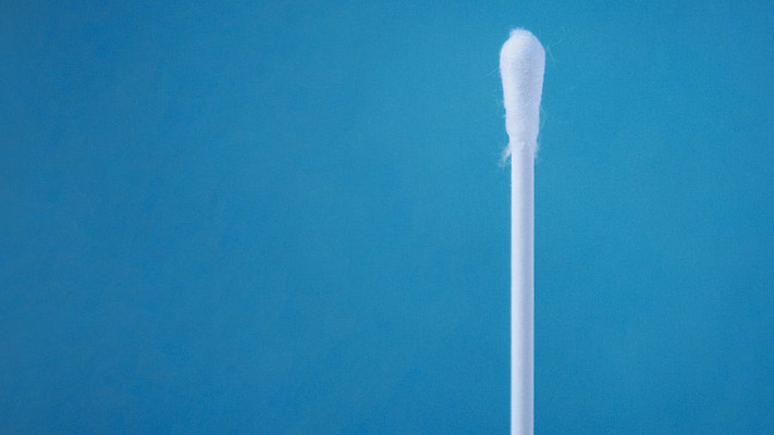 A cotton swab on a blue background